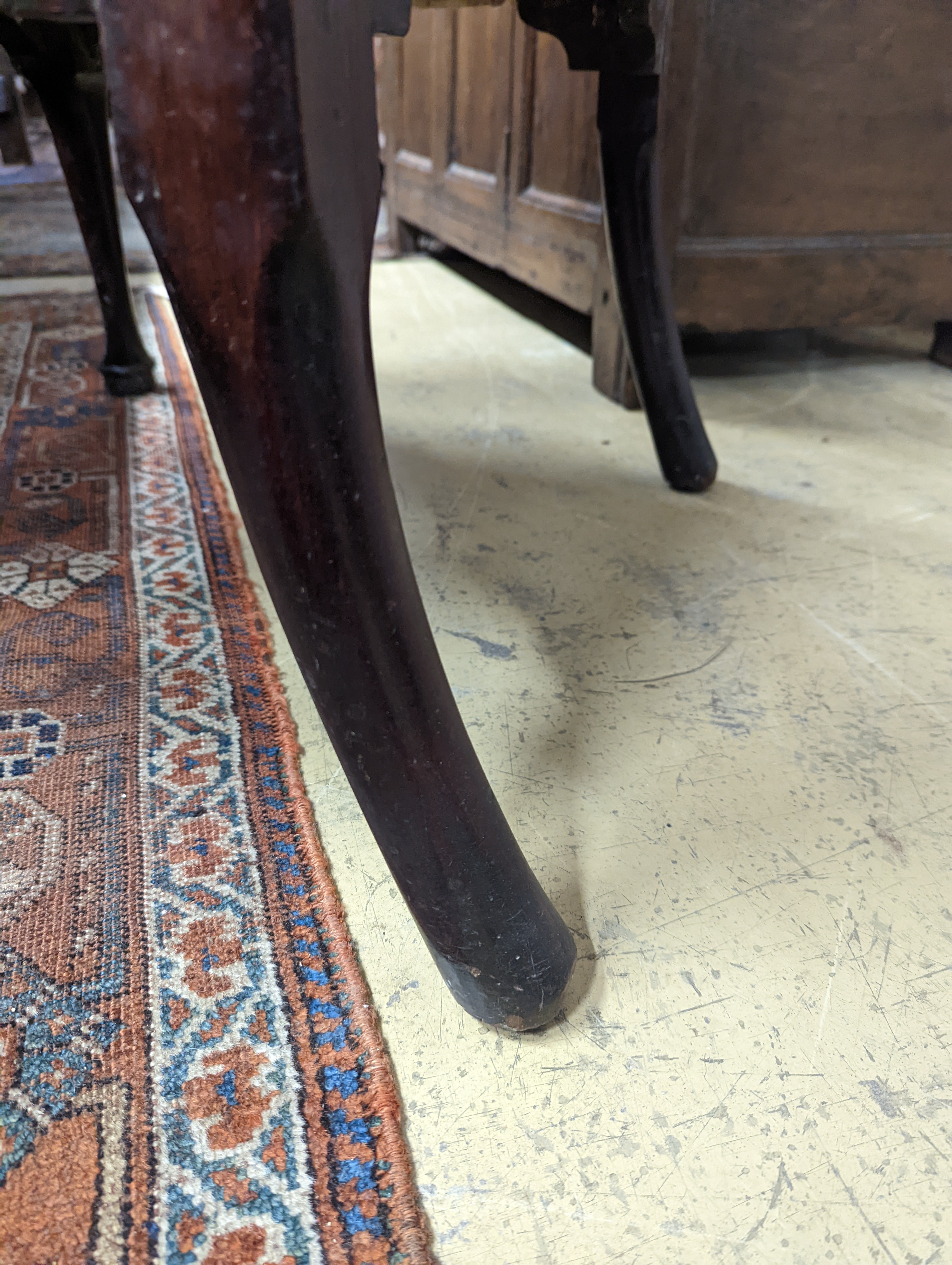 A George II mahogany wingback armchair, with slender cabriole legs and pad feet, width 80cm, depth 66cm, height 126cm